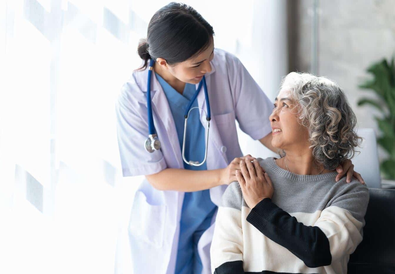 Doctor-patient-smiling-quality-care Doctor and patient receiving quality care smiling at each other